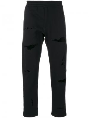 Спортивные брюки с потертой отделкой Alexander McQueen. Цвет: чёрный